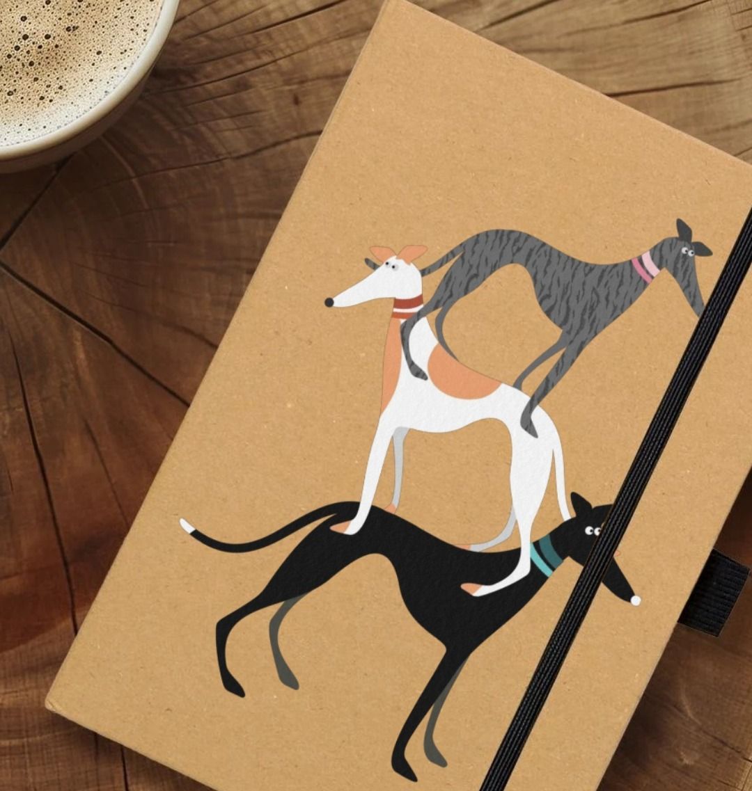 Hound Stack A5 Notebook on a wood work surface with a cappuccino off to one side