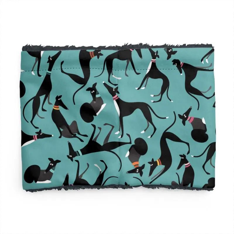 back image of a sherpa fleece lined neck warmer with a turquoise background. The pattern on the outer is a repeat pattern of cute black and white greyhounds in various poses. The lining is black