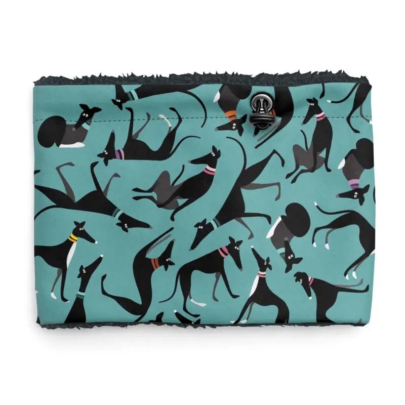 Front image of a sherpa fleece lined neck warmer with a turquoise background. The pattern on the outer is a repeat pattern of cute black and white greyhounds in various poses. There is an elastic pull cord with a toggle for size adjustment. The lining is black