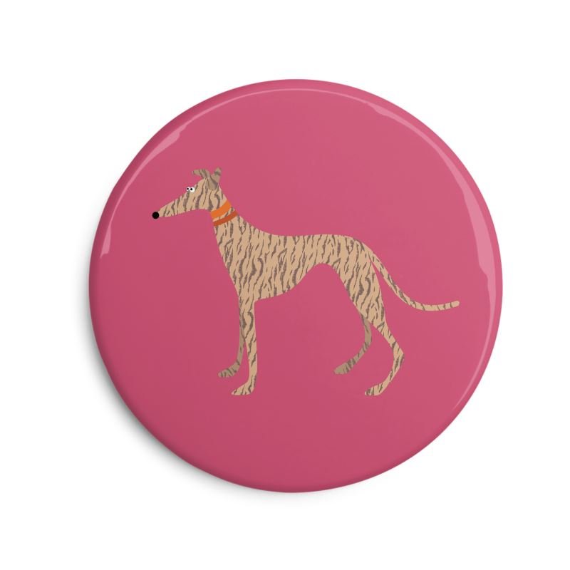 Fridge Magnet. 6cm Round. Showing an  illustration of a cute bridge greyhound. The background is pink. The dog collars are orange.