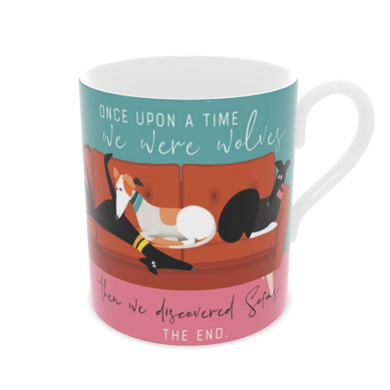Front view of a bone china mug. The background is turquoise and pink.. Wrapped around the mug is an illustrations of 6 greyhounds on a 5 seat orange sofa. On the front and back of the mug the text reads; Once upon a time we were wolves. Then we discovered sofas. The End.