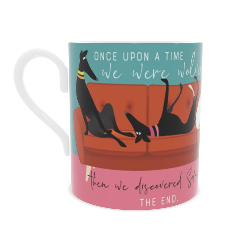 Back view of a bone china mug. The background is turquoise and pink.. Wrapped around the mug is an illustrations of 6 greyhounds on a 5 seat orange sofa. On the front and back of the mug the text reads; Once upon a time we were wolves. Then we discovered sofas. The End.