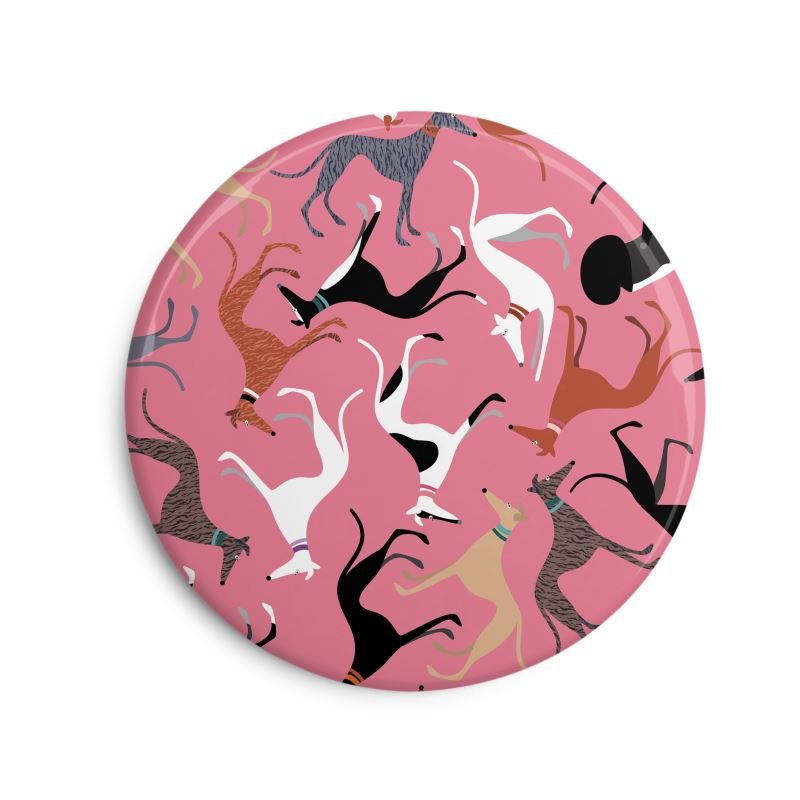 Fridge Magnet. 6cm Round. Pink background with repeat pattern showing illustrations of cute greyhounds with coat colours.
